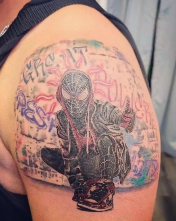 Color tattoo of black spider man with grafitti by Britney Farmer of Sacred Mandala Studio.